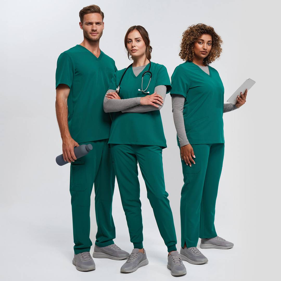 One male and two femaies wearing Onna by Premier scrubs in Clean green whilst holding a water bottle, clipboard and stethoscope