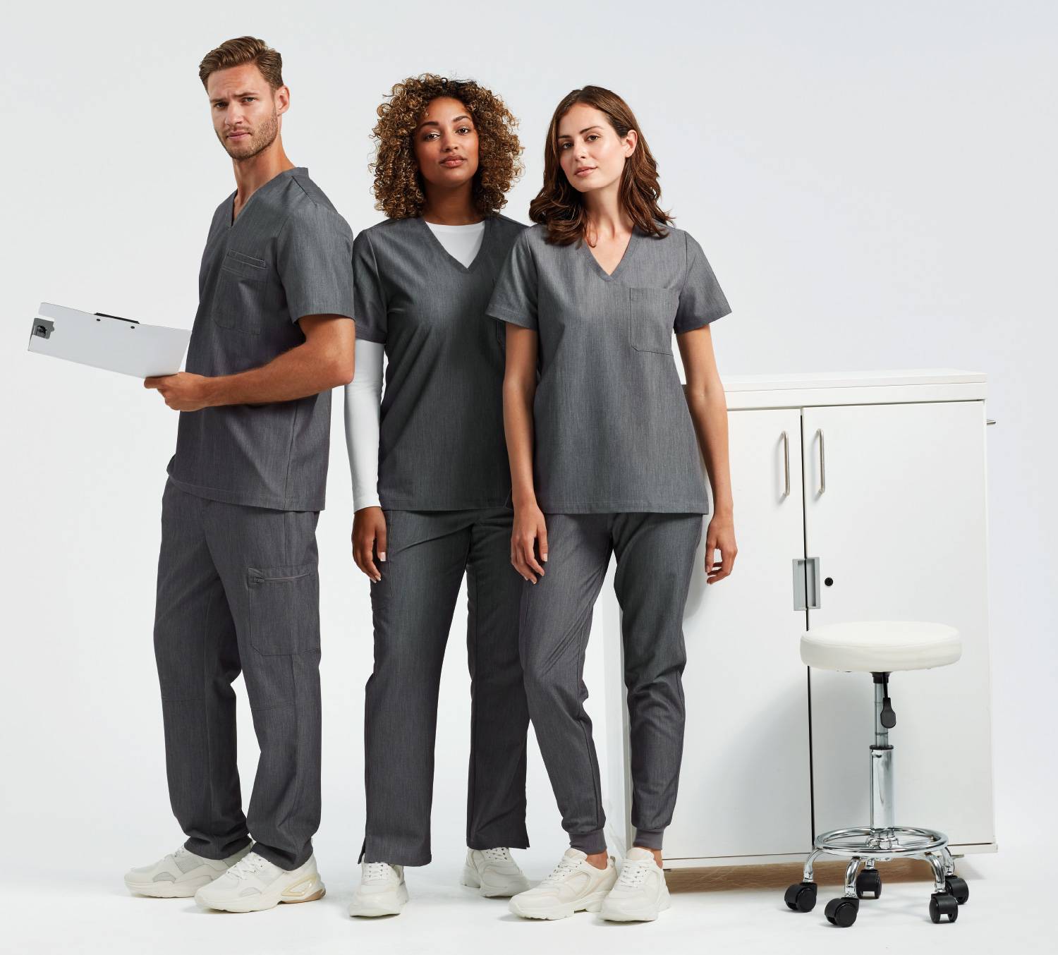 A man and two women wearing Onna by Premier Dynamo Grey scrubs.